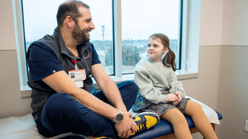 Dr. Israel Nosnik with patient in the pediatric urology department at Children's Health.