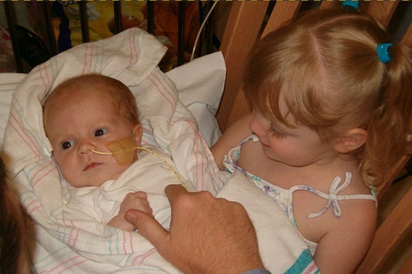 Little girl holding baby