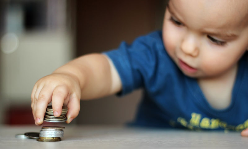Niño pequeño jugando con monedas
