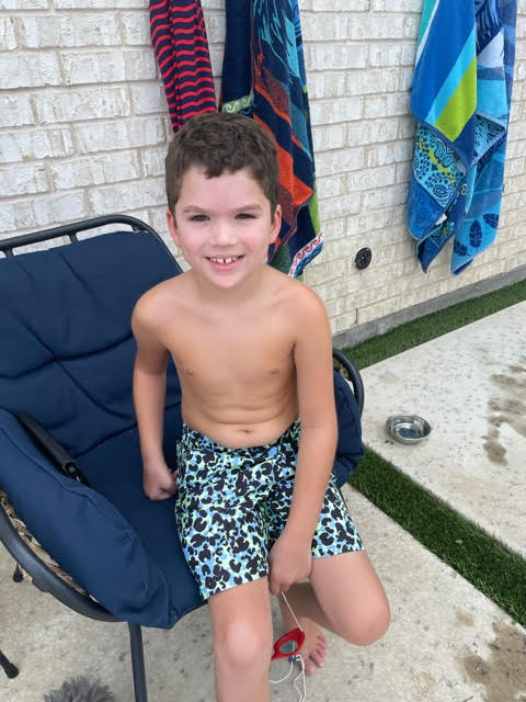 Young boy getting ready to go swimming