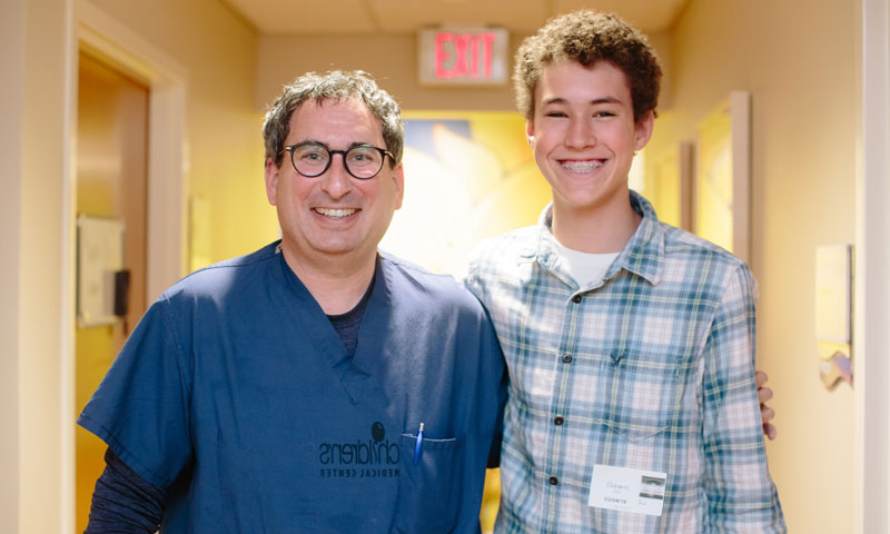 Austin and his doctor standing side by side